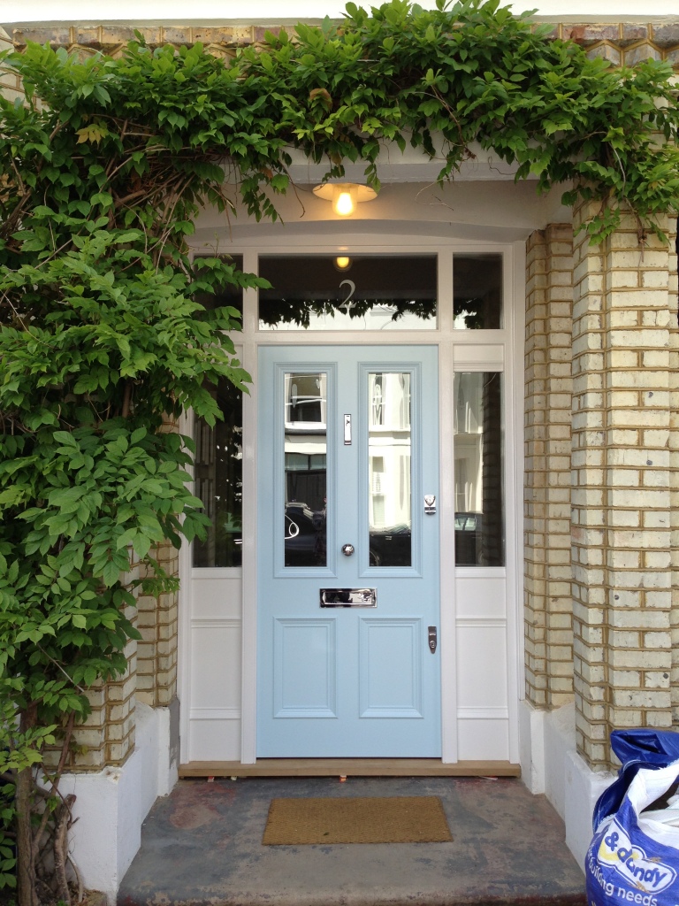 Victorian style chrome furniture completes the look of this Victorian front door.
