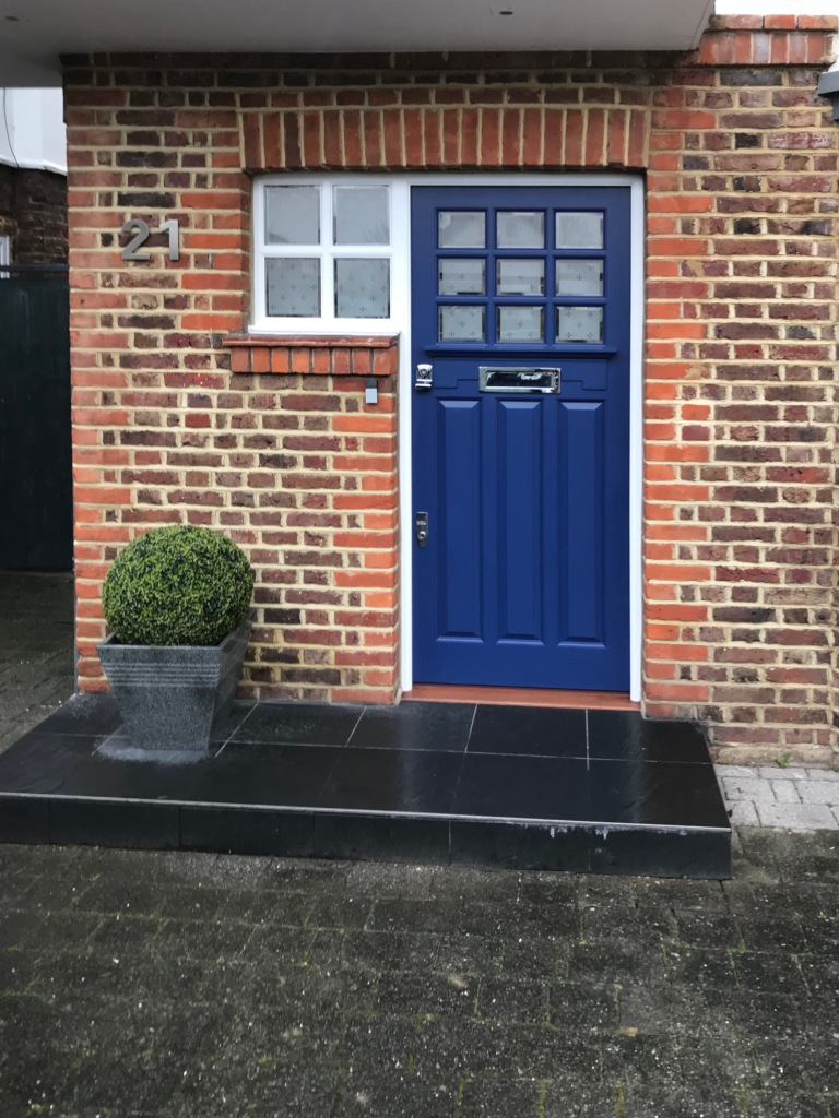 This bespoke blue Victorian glass panel door has remastered frosted sidelights with an opaque glaze and etching detail. 