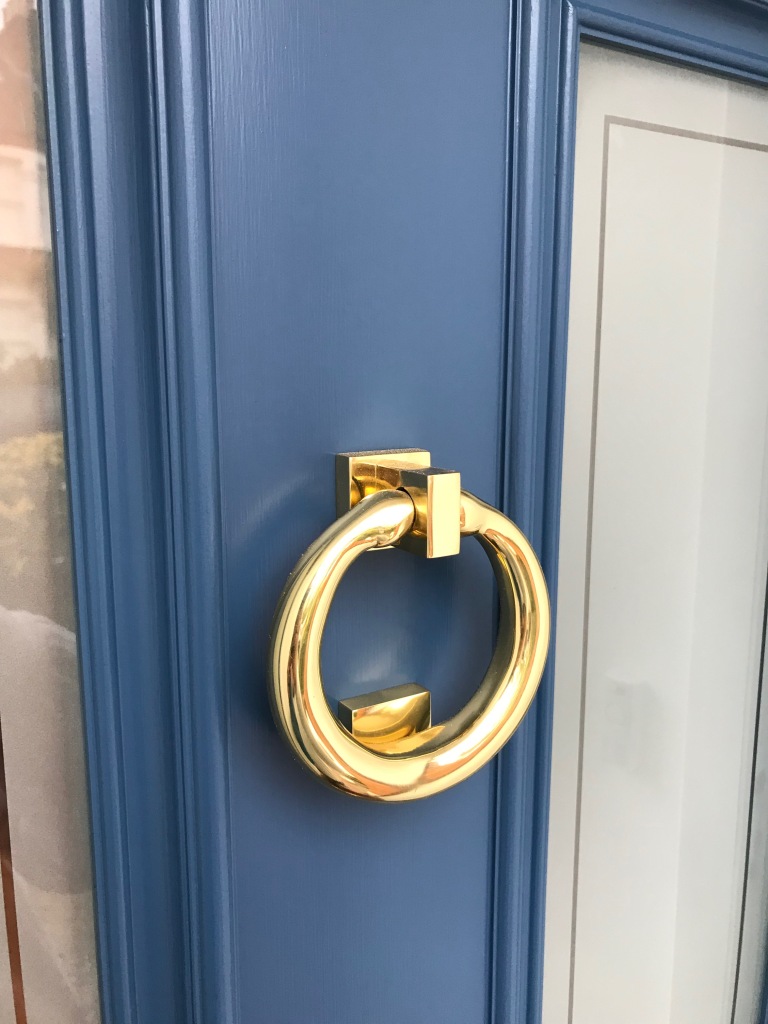 The Deco influence is apparent in this 20s/30s design with matte blue finish and brass door furniture.